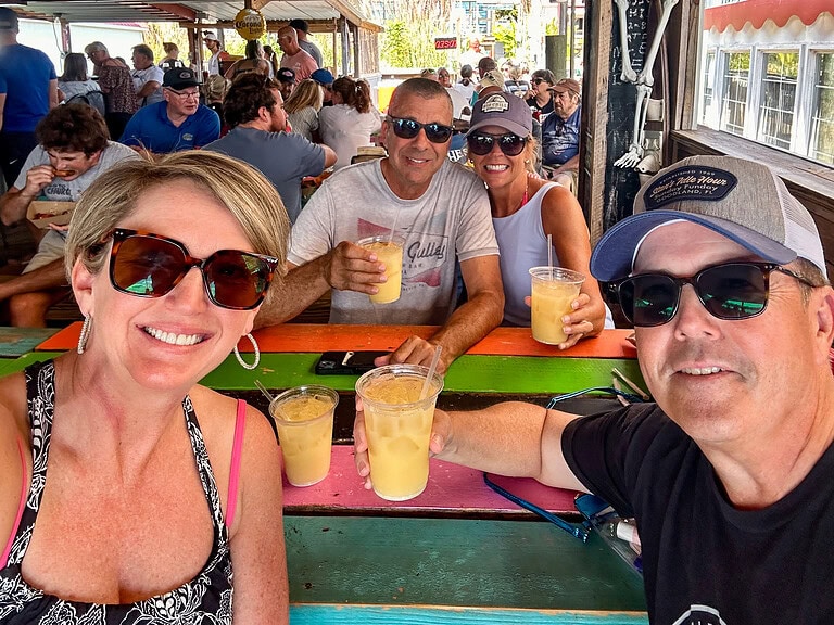 Two couples with tropical drinks at Portside, a popular bar at Smith Mountain Lake, VA.