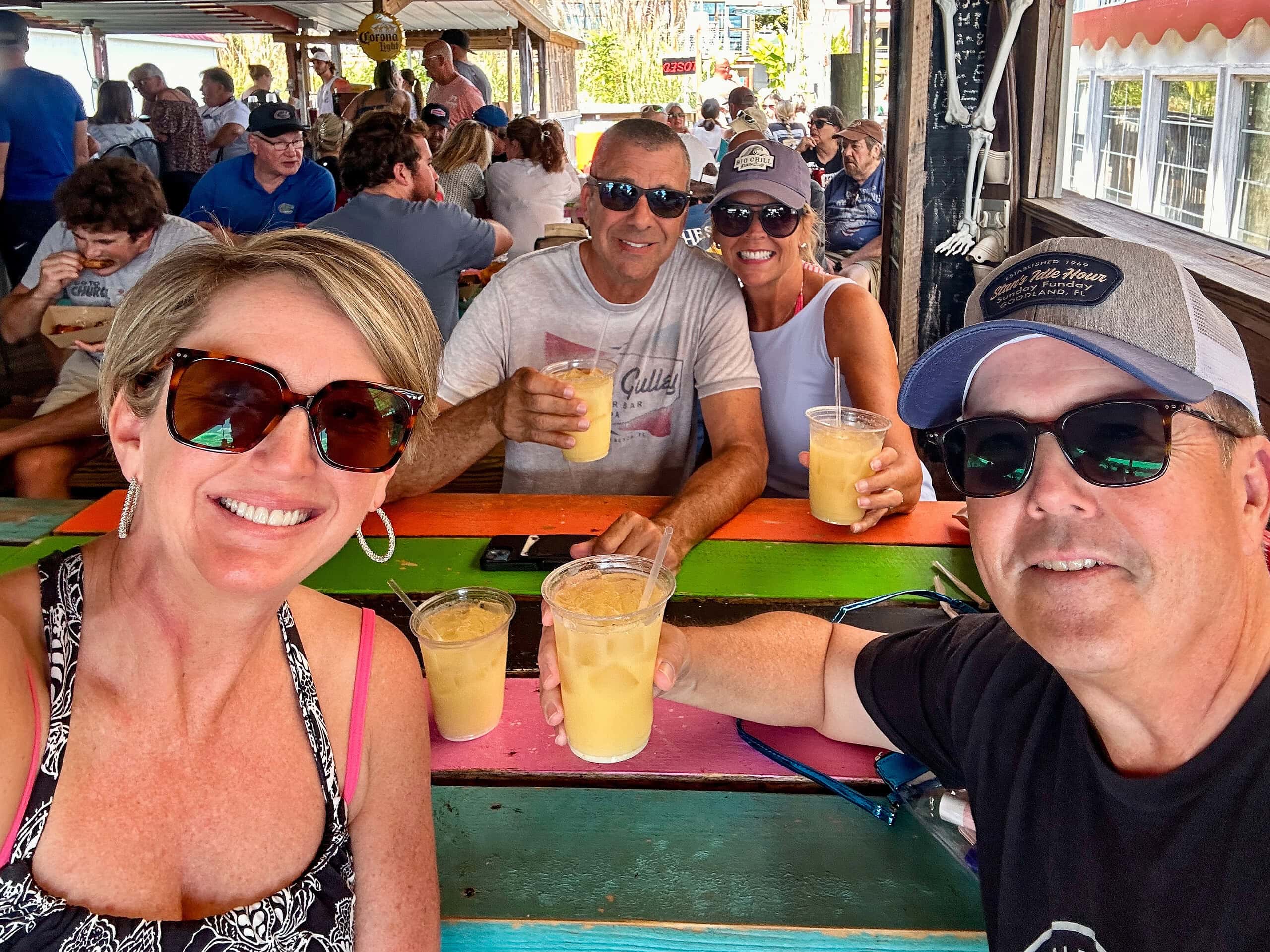 Two couples with tropical drinks at Portside, a popular bar at Smith Mountain Lake, VA.