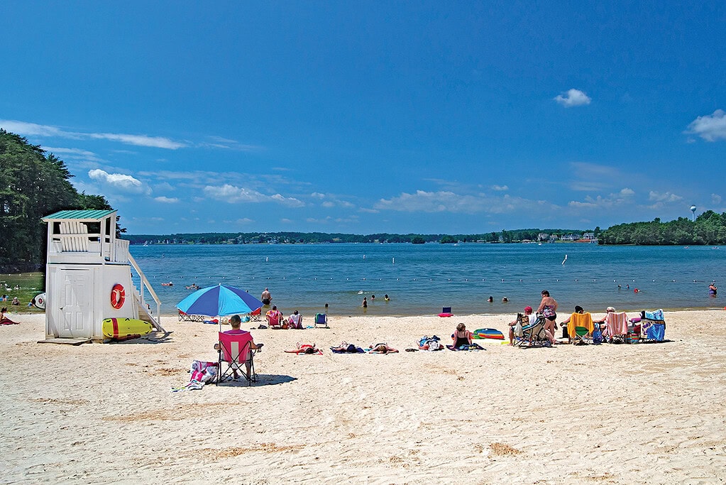 Families enjoy the sand and beach at Smith Mountain Lake Community Park in Virginia.