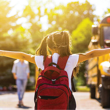 a young student boarding a school bus