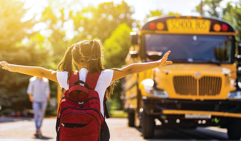 a young student boarding a school bus