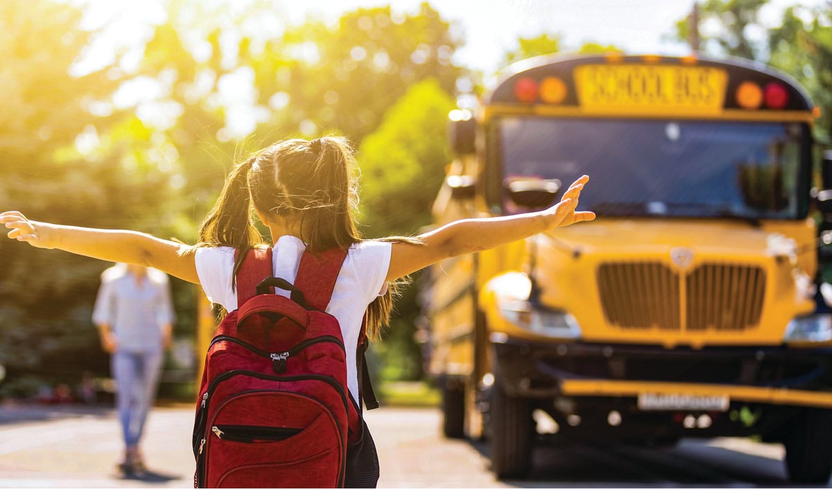 a young student boarding a school bus