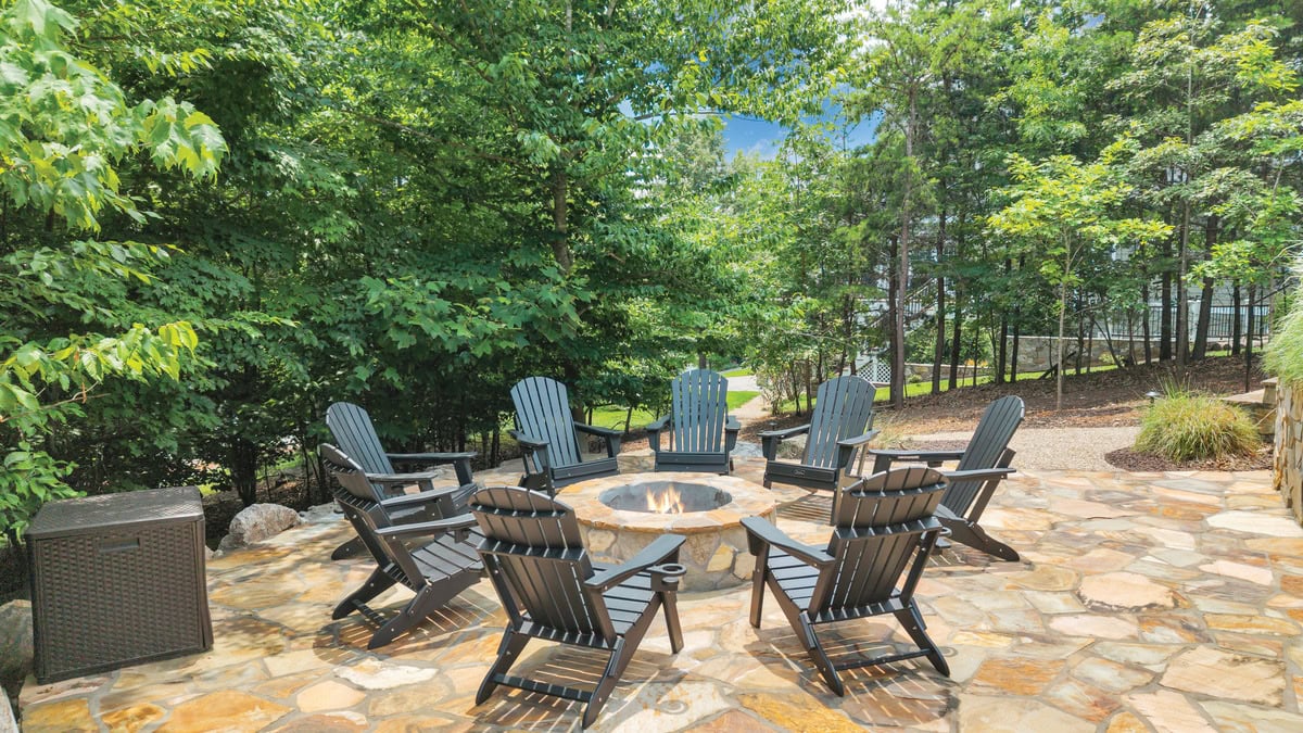 Terraced patio with firepit and Adirondack chairs outside the Bourbon Barn

