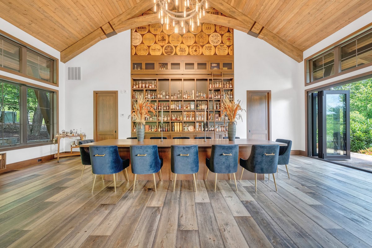 Thirteen-by-four-foot oak tasting table surrounded by twelve plush chairs