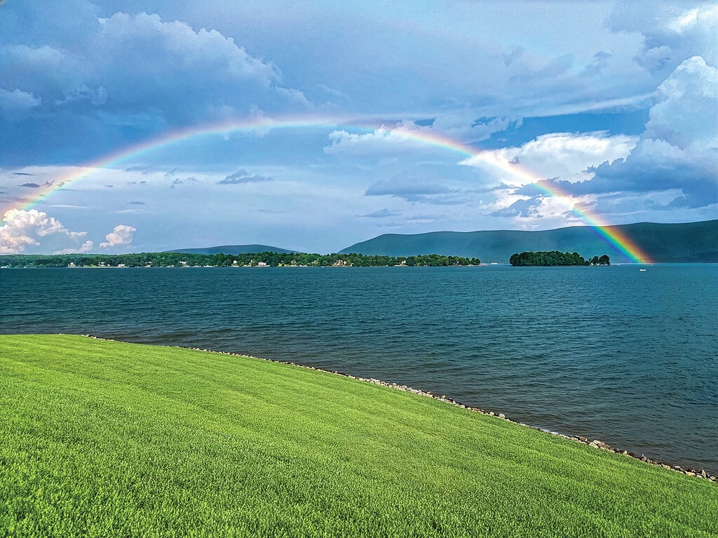 A rainbow over Smith Mountain Lake with the mountain in the background.